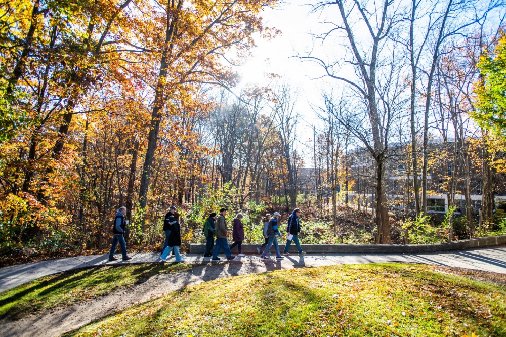 Group walking behind the dorms